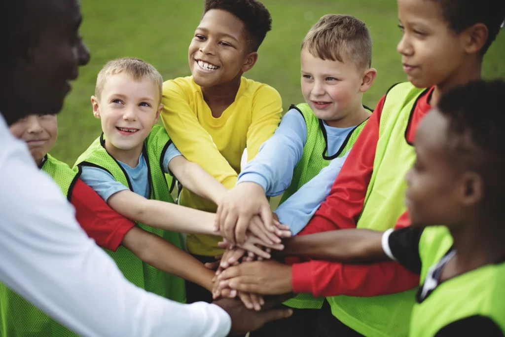 Kids wearing a football uniform, actively participating in a team, developing social skills