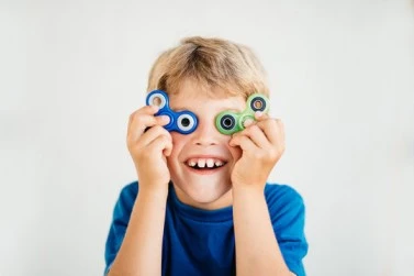 Image of kids with ADHD playing with hand spinners, demonstrating effective management techniques