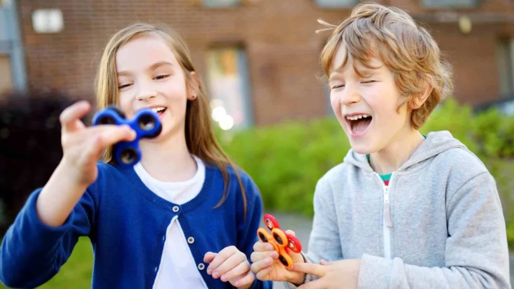 Image of kids with Attention Deficit Hyperactivity Disorder playing with hand spinners