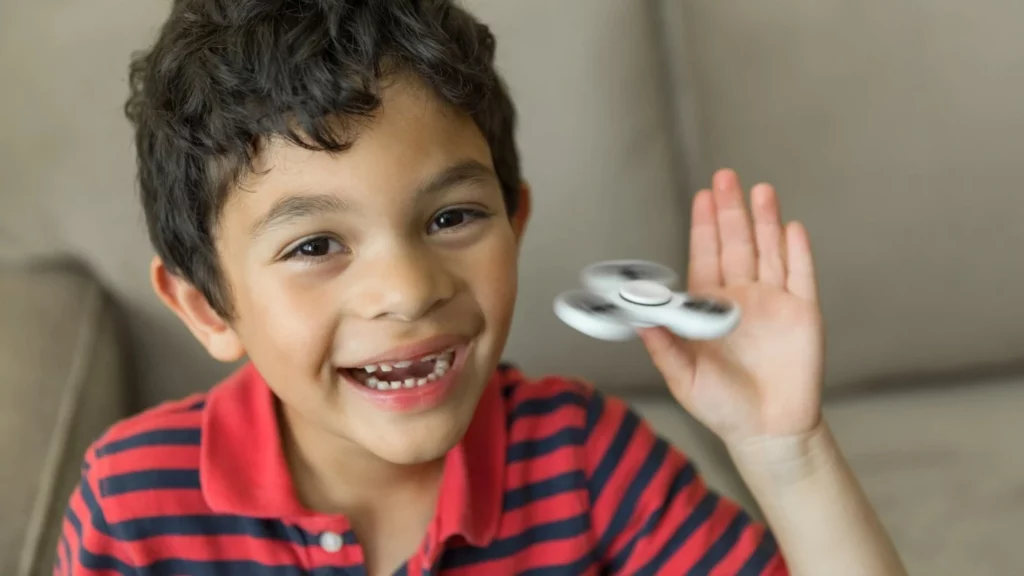 Image of kids playing with hand spinners, showcasing effective parenting strategies